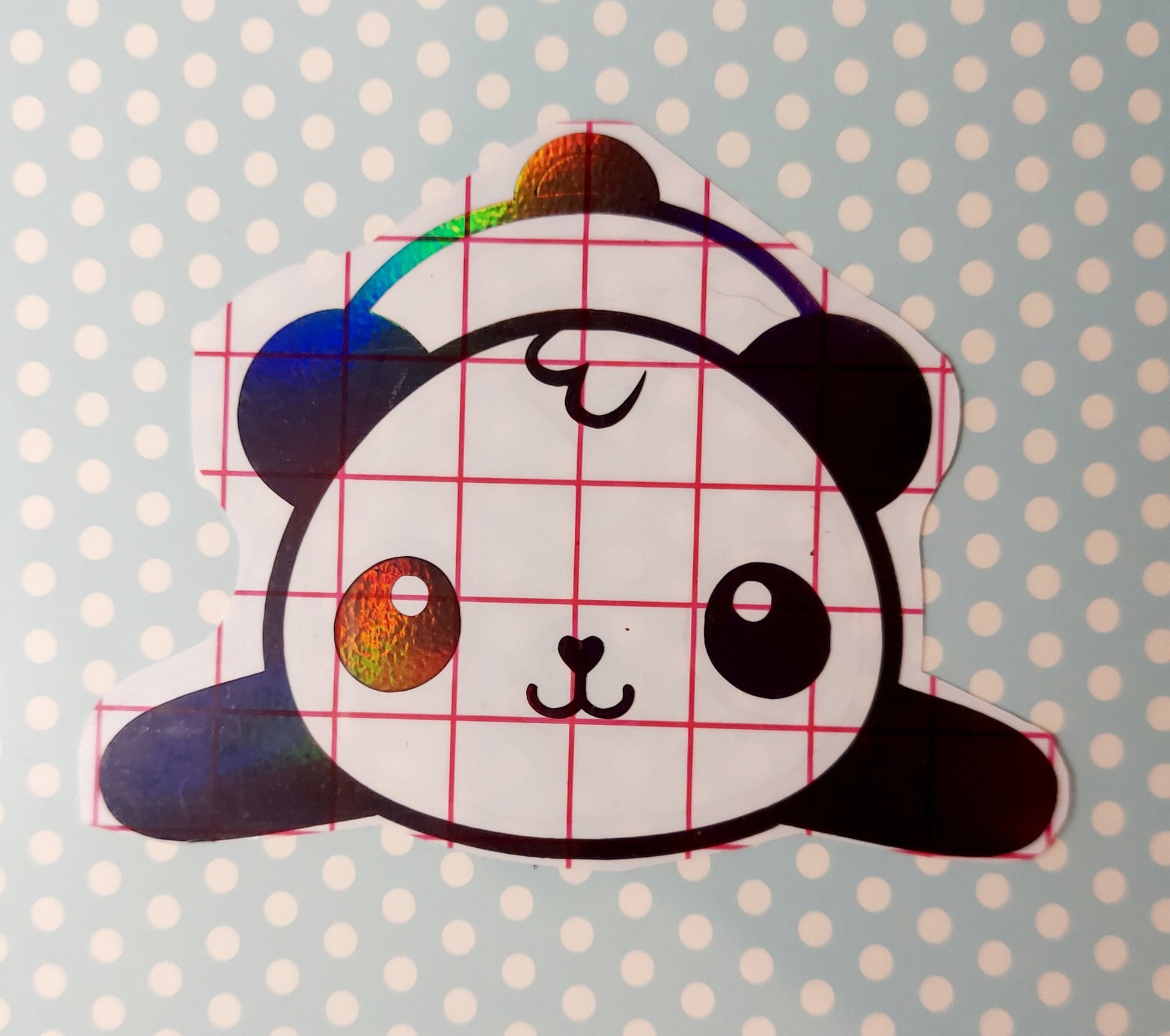 Panda sticker made with holographic permanent vinyl. The cute cartoon panda is lying on his belly with his tail visible and his front legs out to the side. The sticker isabout 4&quot; wide and almost 3&quot; tall at the tallest spot.